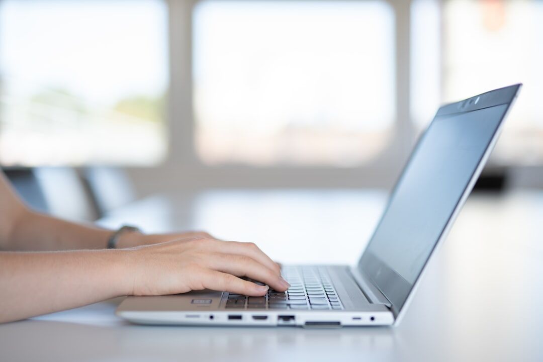 writer typing on laptop