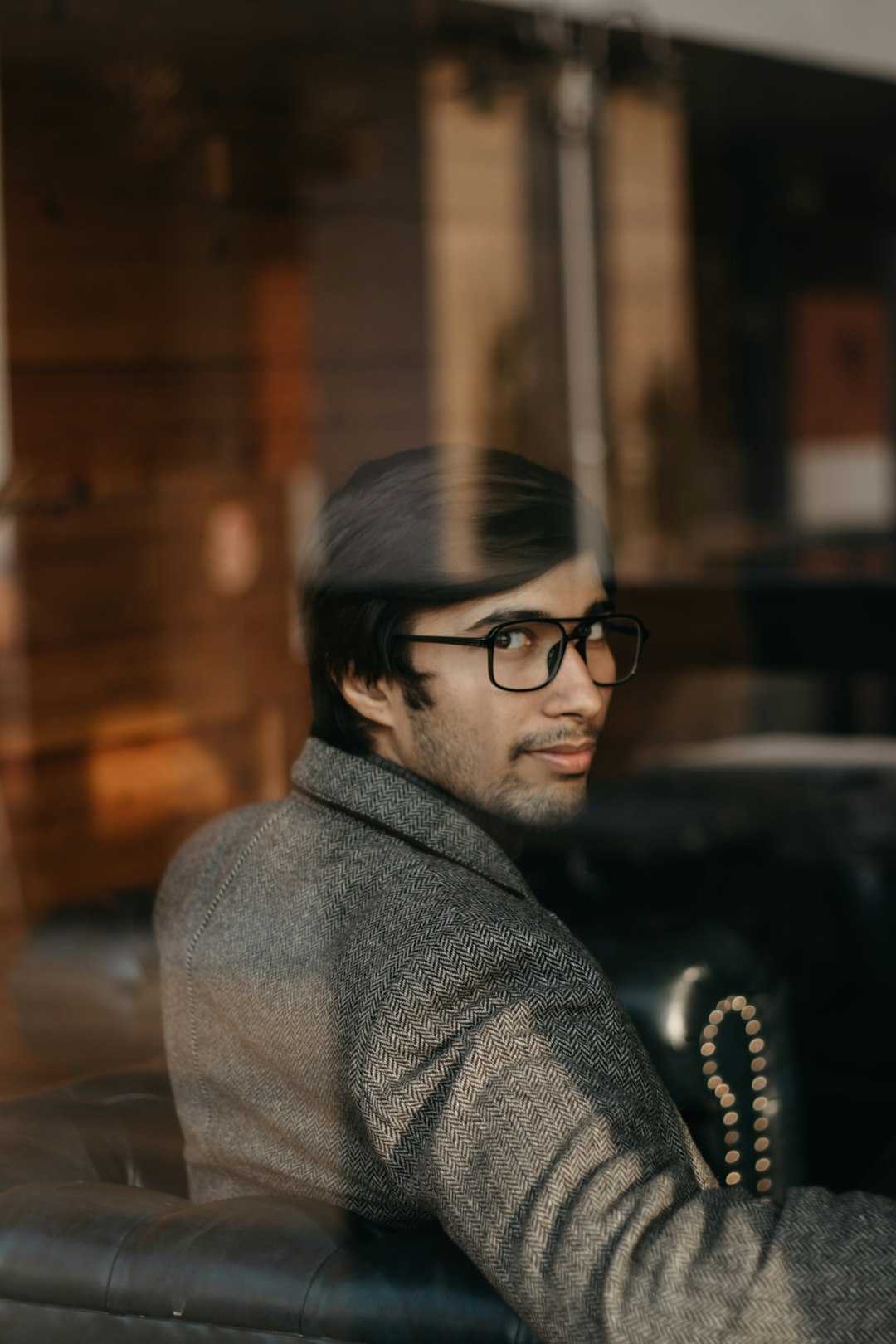 Portrait of a middle-aged Croatian male writer in a tweed jacket and round glasses